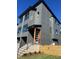 Stylish three-story home, gray siding, private fenced yard, and modern entryway at 1000 Addison Pl # 102, Raleigh, NC 27610