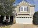 Two-story house with beige siding, white garage door, and landscaping at 112 Ryder Cup Cir, Raleigh, NC 27603