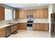L-shaped kitchen with light wood cabinets and stainless steel appliances at 112 Ryder Cup Cir, Raleigh, NC 27603