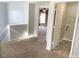 Upstairs hallway with carpet, doors to bedrooms and laundry at 112 Ryder Cup Cir, Raleigh, NC 27603