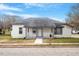 Charming renovated bungalow with a white brick facade, gray roof, and a welcoming front porch at 115 Kerr Dr, Roxboro, NC 27573