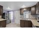 Modern kitchen with dark brown cabinets, granite countertops, and stainless steel appliances at 115 Kerr Dr, Roxboro, NC 27573