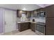 Modern kitchen with dark brown cabinets, granite countertops, and stainless steel appliances at 115 Kerr Dr, Roxboro, NC 27573