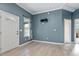 Light and airy living room with gray walls, wood-look flooring, and a view of the backyard at 115 Kerr Dr, Roxboro, NC 27573