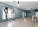 Open living room with light gray walls, wood-look floors, and a ceiling fan at 115 Kerr Dr, Roxboro, NC 27573