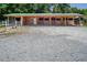 View of a barn with multiple stalls and a gravel area at 1416 Chambers Rd, Rougemont, NC 27572