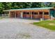 View of a barn with multiple stalls and a gravel area at 1416 Chambers Rd, Rougemont, NC 27572