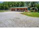 View of a barn with multiple stalls and a gravel area at 1416 Chambers Rd, Rougemont, NC 27572