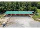 Green roofed barn with multiple stalls and tractor at 1416 Chambers Rd, Rougemont, NC 27572