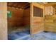 Interior of a barn stall with hay on the floor at 1416 Chambers Rd, Rougemont, NC 27572