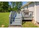 Back deck with gray railings, steps, and a built-in grill at 1416 Chambers Rd, Rougemont, NC 27572
