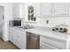 Modern kitchen with stainless steel appliances and white cabinets at 1416 Chambers Rd, Rougemont, NC 27572