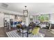 Open concept dining area with modern light fixtures and hardwood floors at 223 Augusta Pond Way # 158, Raleigh, NC 27603