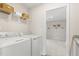 Bright laundry room with washer, dryer, and ample shelving at 223 Augusta Pond Way # 158, Raleigh, NC 27603