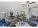 Spacious living room with hardwood floors, gray sofa, and a ceiling fan at 223 Augusta Pond Way # 158, Raleigh, NC 27603