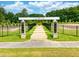 Entrance to Georgia's Landing Bark Park, featuring a brick-paved pathway and modern signage at 223 Augusta Pond Way # 158, Raleigh, NC 27603