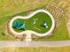 Aerial view of a playground with artificial turf and modern play equipment at 223 Augusta Pond Way # 158, Raleigh, NC 27603