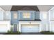 Two-story townhome with gray siding, white trim, and a two-car garage at 283 Broomside Ave, Raleigh, NC 27603