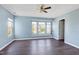 Spacious bedroom with light blue walls, dark wood floors and ceiling fan at 6044 Ladish Ln, Raleigh, NC 27610