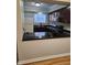 Kitchen features dark wood cabinets and a granite breakfast bar at 7030 Longstreet Dr # A, Raleigh, NC 27615