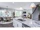 Modern kitchen with white cabinets, granite countertops, island, and breakfast nook at 773 Denburn Pl, Raleigh, NC 27603