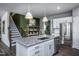 Modern kitchen with white cabinets, granite countertops, and a large island at 773 Denburn Pl, Raleigh, NC 27603