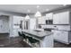 Modern kitchen with white cabinets, granite countertops, and a large island at 773 Denburn Pl, Raleigh, NC 27603