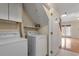 Small laundry area with washer, dryer, and shelving at 90 Forest Oaks Dr, Durham, NC 27705