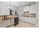 Modern kitchen featuring granite countertops and white cabinets at 908 Carpenter Town Ln, Cary, NC 27519