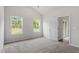 Main bedroom with two large windows, carpeted floor, and access to a deck at 101 Shelfit Trl, Oxford, NC 27565