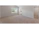 Spacious main bedroom with large window, carpet, and ensuite bathroom at 107 Scoville St, Oxford, NC 27565