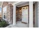 Inviting front entry with stone accents and a covered porch at 1675 Winter Wren Cir, Wake Forest, NC 27587