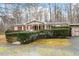 Tan mobile home with red shutters and a well-manicured yard at 1705 Old Nc 10 Hwy, Hillsborough, NC 27278