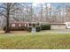 Tan mobile home with red shutters, front porch, and landscaped yard at 1705 Old Nc 10 Hwy, Hillsborough, NC 27278