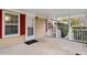 Covered porch with white railing, door, and welcome mat at 1705 Old Nc 10 Hwy, Hillsborough, NC 27278