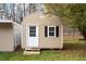 Tan colored storage shed with white door and black shutters at 1705 Old Nc 10 Hwy, Hillsborough, NC 27278