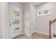 Modern entryway with glass front door and coat closet at 1917 A Essex, Durham, NC 27704