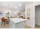 Kitchen island with seating, white quartz countertop, and modern light fixtures at 1917 A Essex, Durham, NC 27704