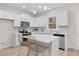 Modern kitchen with white cabinets, quartz countertops, and breakfast bar at 1917 A Essex, Durham, NC 27704