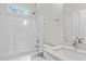 Modern bathroom with white tub/shower combo and quartz vanity at 1917 B Essex Rd, Durham, NC 27704