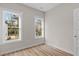 Well-lit bedroom with hardwood floors and two large windows at 1917 B Essex Rd, Durham, NC 27704