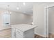 Modern kitchen island with white cabinets and quartz countertop at 1917B Essex Rd, Durham, NC 27704