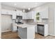 Modern kitchen with white cabinets and quartz countertops at 1917 B Essex Rd, Durham, NC 27704