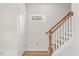 Modern staircase with wooden handrail and white risers at 1917 B Essex Rd, Durham, NC 27704