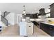 Modern kitchen with black cabinets, marble island, and stainless steel appliances at 209 Big Bradley Dr, Wendell, NC 27591