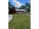 View of the brick house from the side yard, showing a carport at 209 N Watauga Ave, Dunn, NC 28334