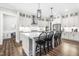 Modern kitchen with white cabinets, large island, and stainless steel appliances at 212 Chickasaw Plum Dr, Holly Springs, NC 27540