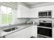 White kitchen with granite countertops and stainless steel appliances at 218 Elyse Overlook Loop, Sanford, NC 27332