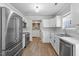 Modern kitchen with white cabinets and stainless steel appliances at 235 N Fuquay Springs Ave, Fuquay Varina, NC 27526