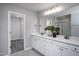 Double vanity bathroom with walk-in shower and linen closet at 295 Broomside Ave, Raleigh, NC 27603